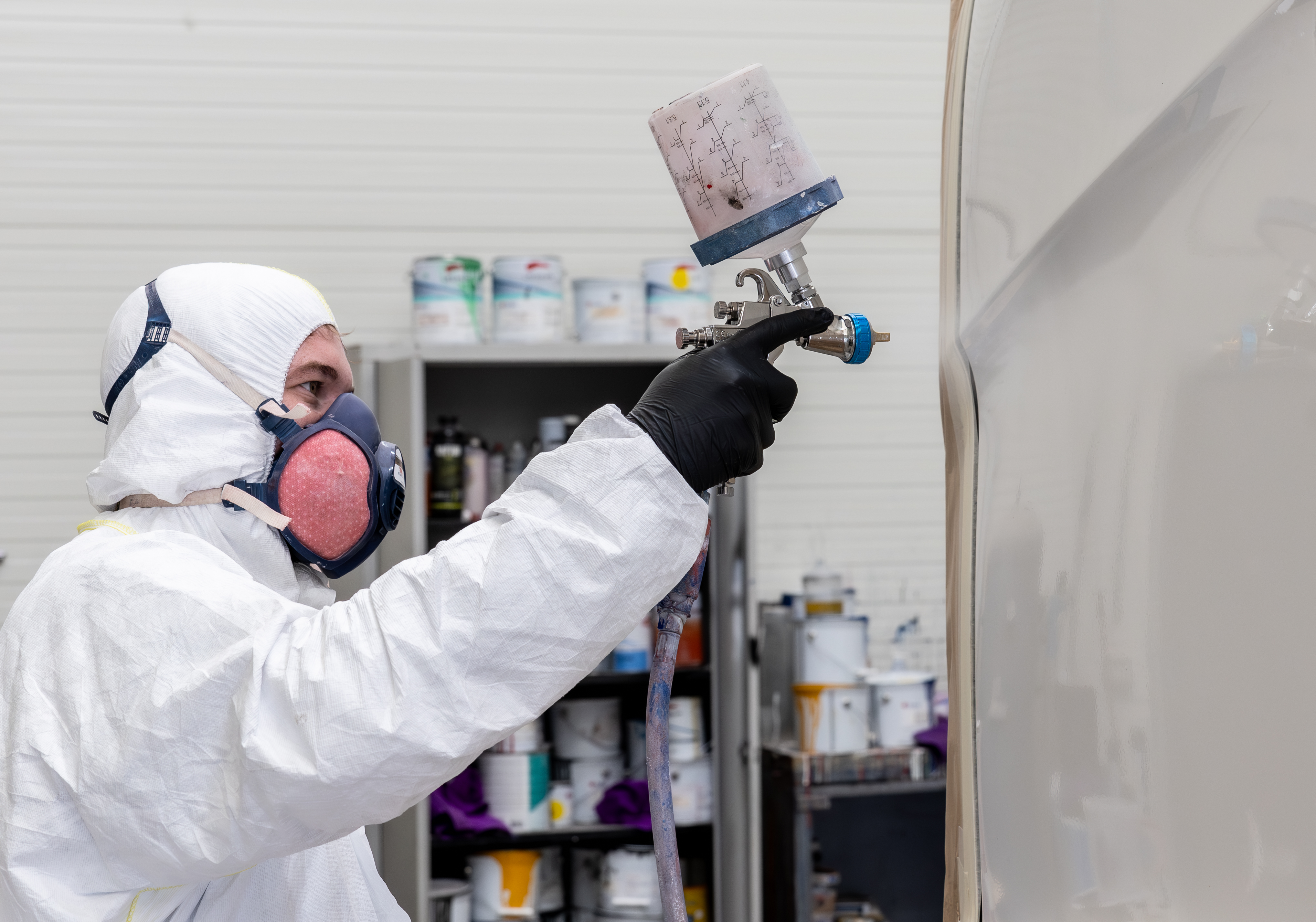 Smithbros worker painting a truck